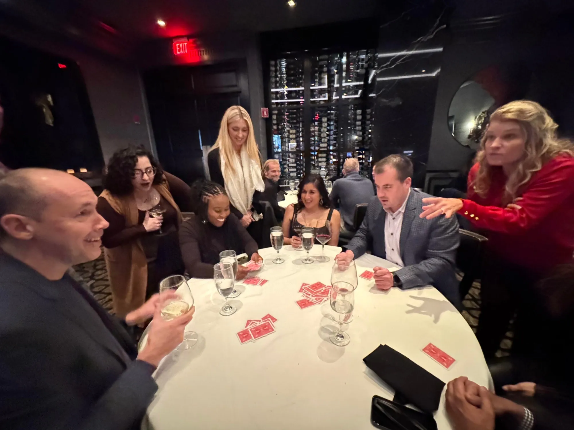 Chris performing card magic for a table of guests