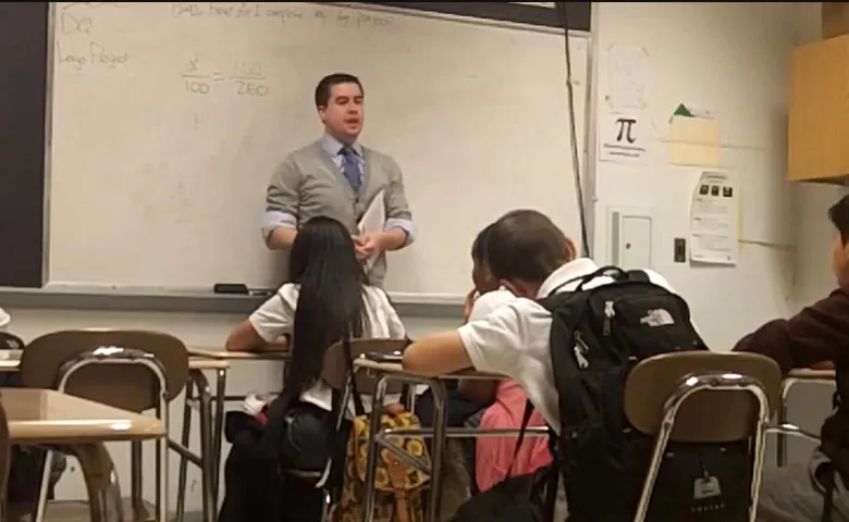 Chris teaching a 7th grade math class at the whiteboard